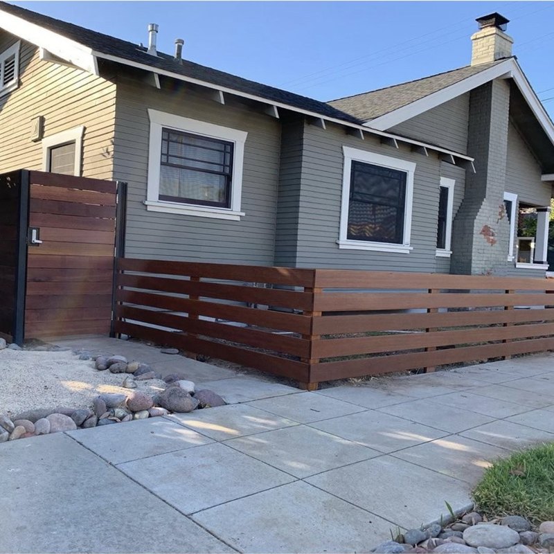 Horizontal slat fence with a solid privacy gate installed by Fence Tech