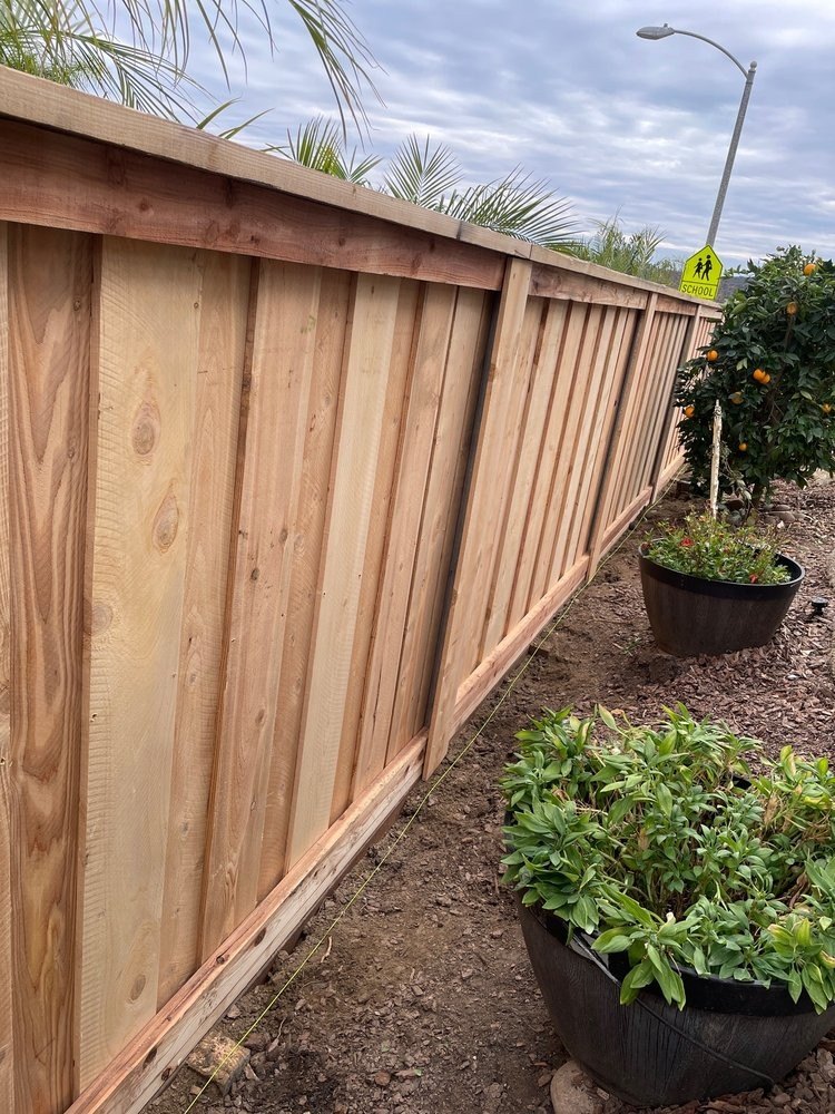 Newly installed cedar board fence before staining, by Fence Tech