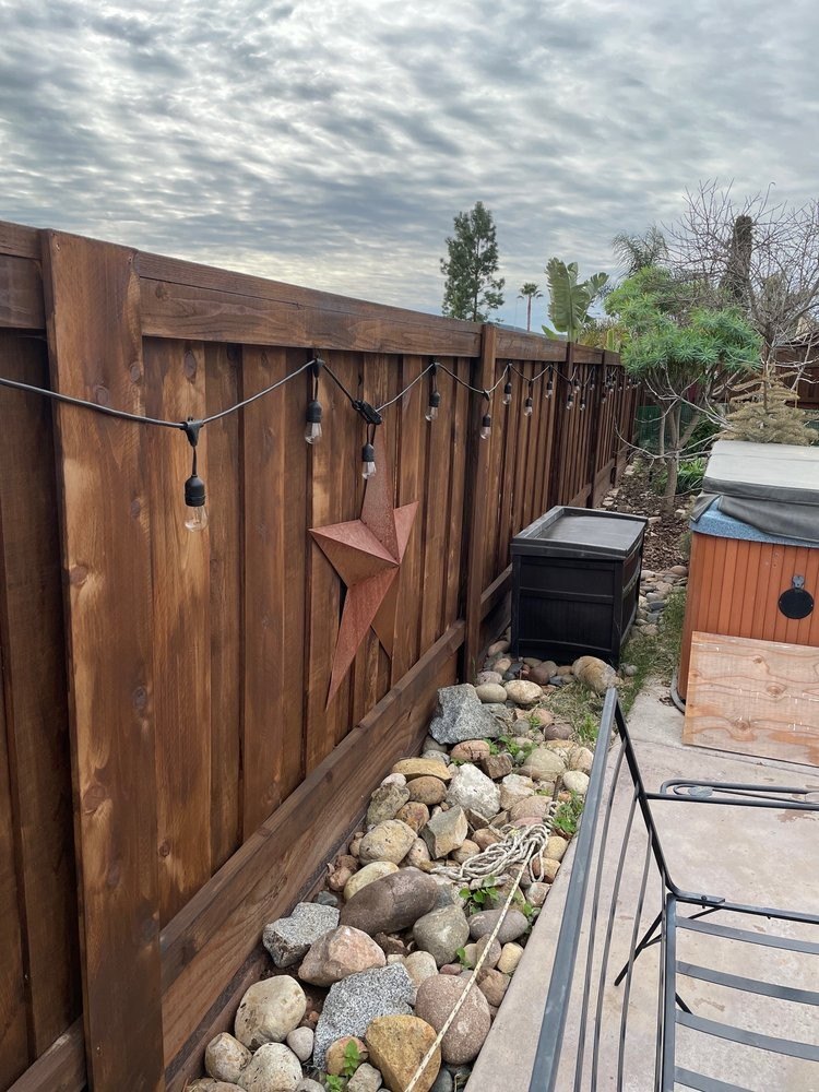 Stained wood backyard fence installed by Fence Tech